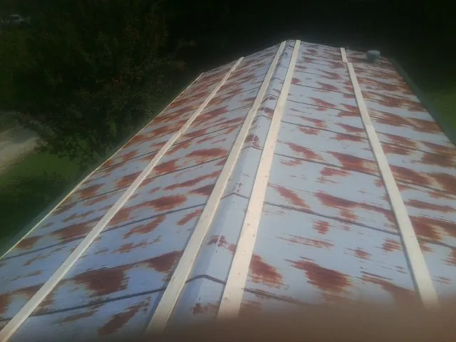 Rusted metal roof panels with new wood purlins before replacement — Storm Damage Roof Repair in Allamuchy by Roofing Brothers
