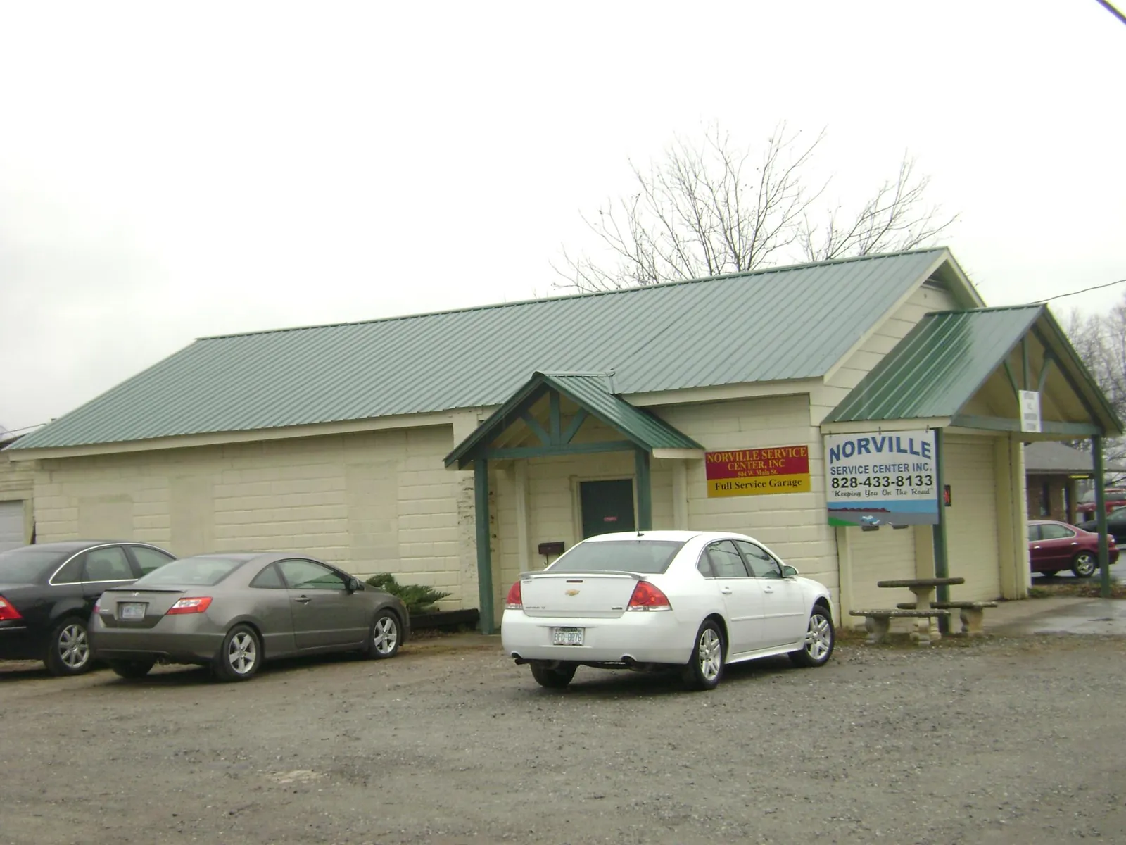 Green metal roof on a service garage with a covered entry in Allamuchy