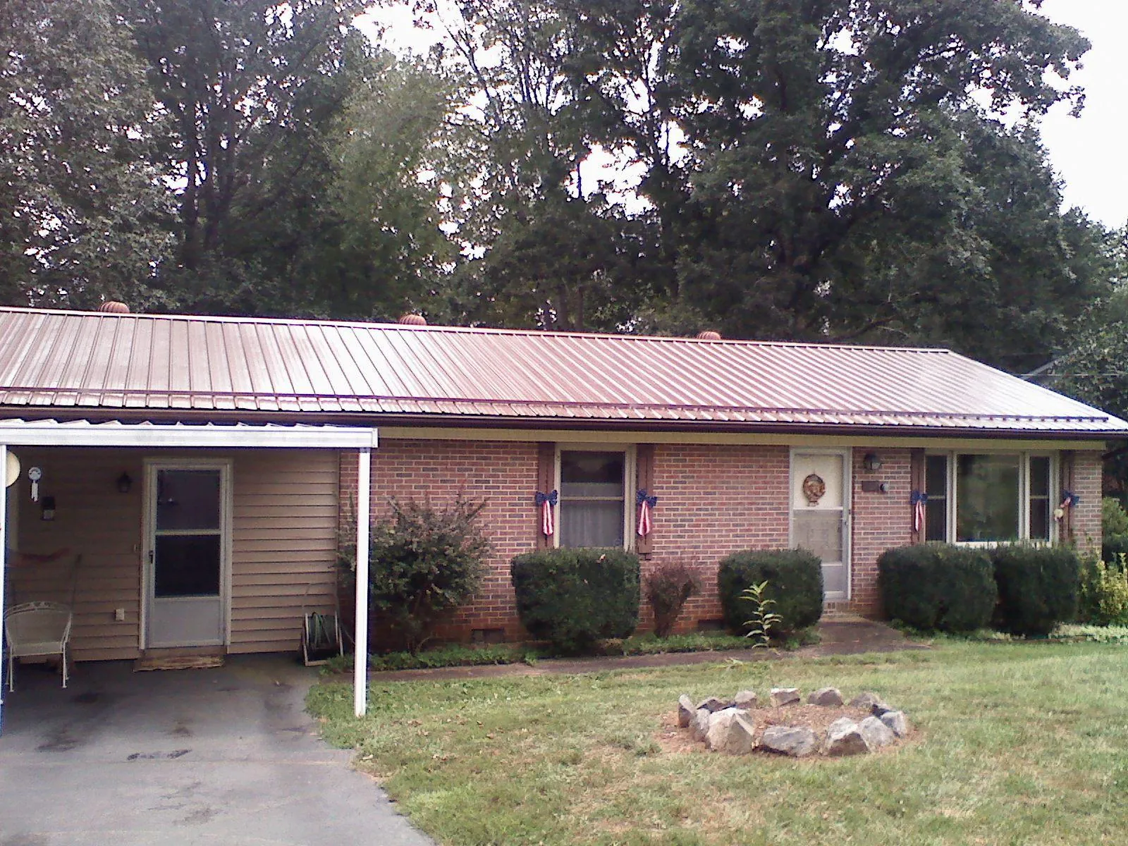 Bronze metal roof and carport on a brick ranch home — Roof Repair work by our crew in Allamuchy
